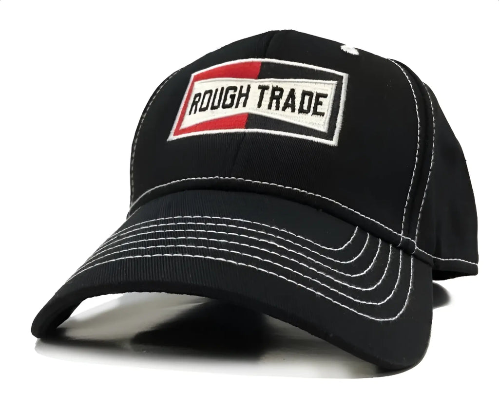 Black baseball cap with white stitching and rectangular rough trade patch in red black and white colors