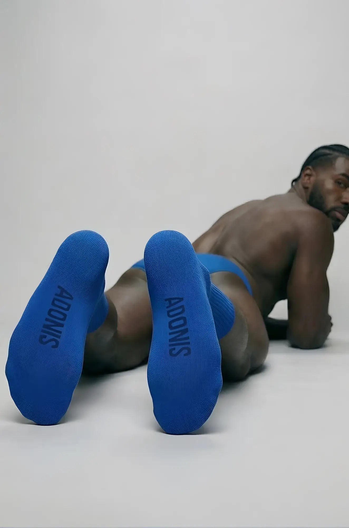 Royal blue socks with adonis printed in black on the heel shown from the back in a 2-piece set