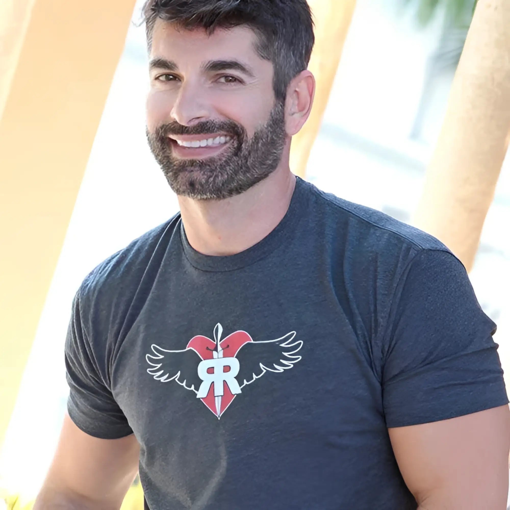 Dark heather gray ruff riders commitment short sleeved t shirt with red heart white wings and r emblem in size L