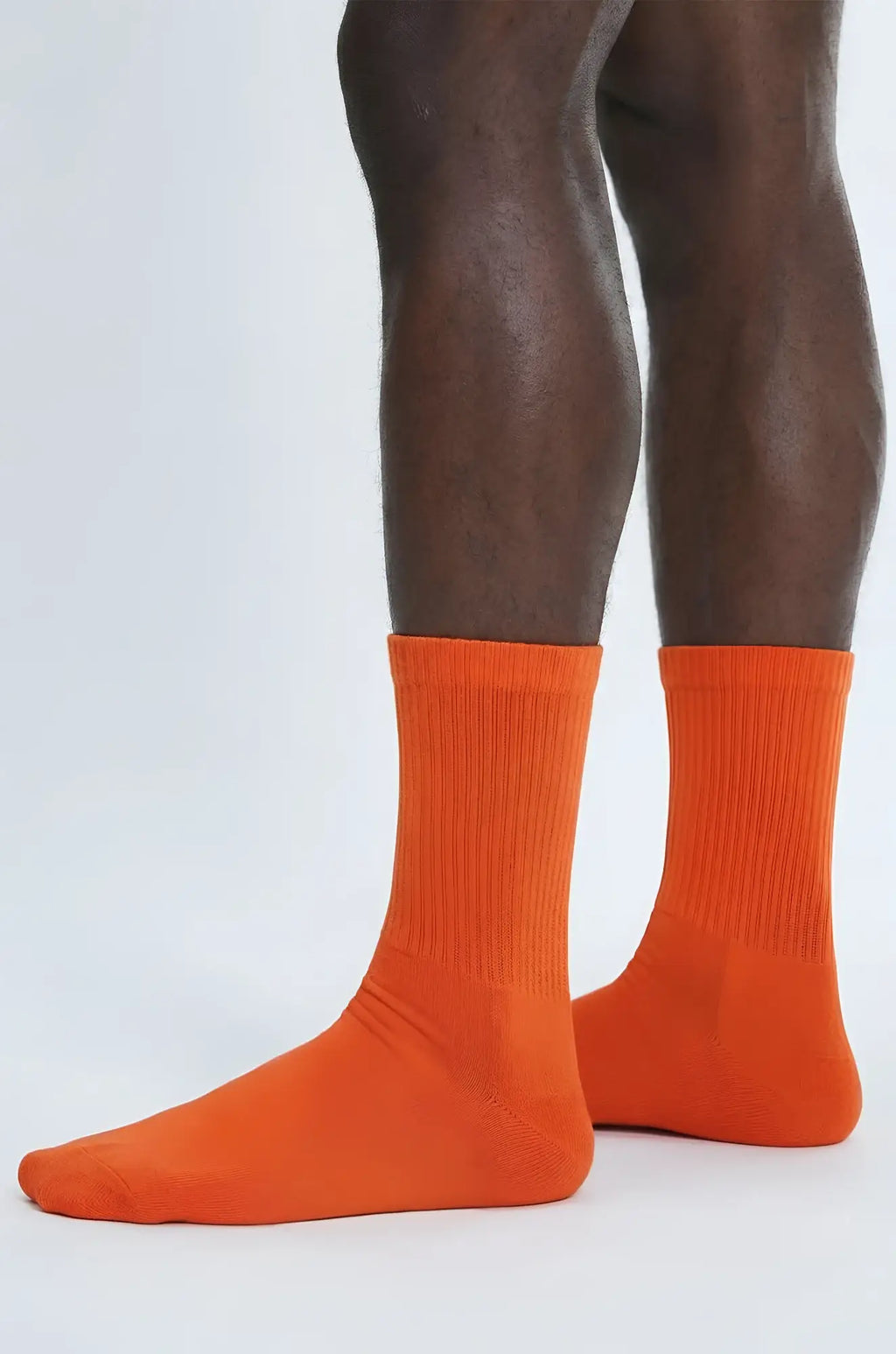 Rust orange crew sock featuring bright orange ribbed crew-length cotton fabric for comfortable everyday wear