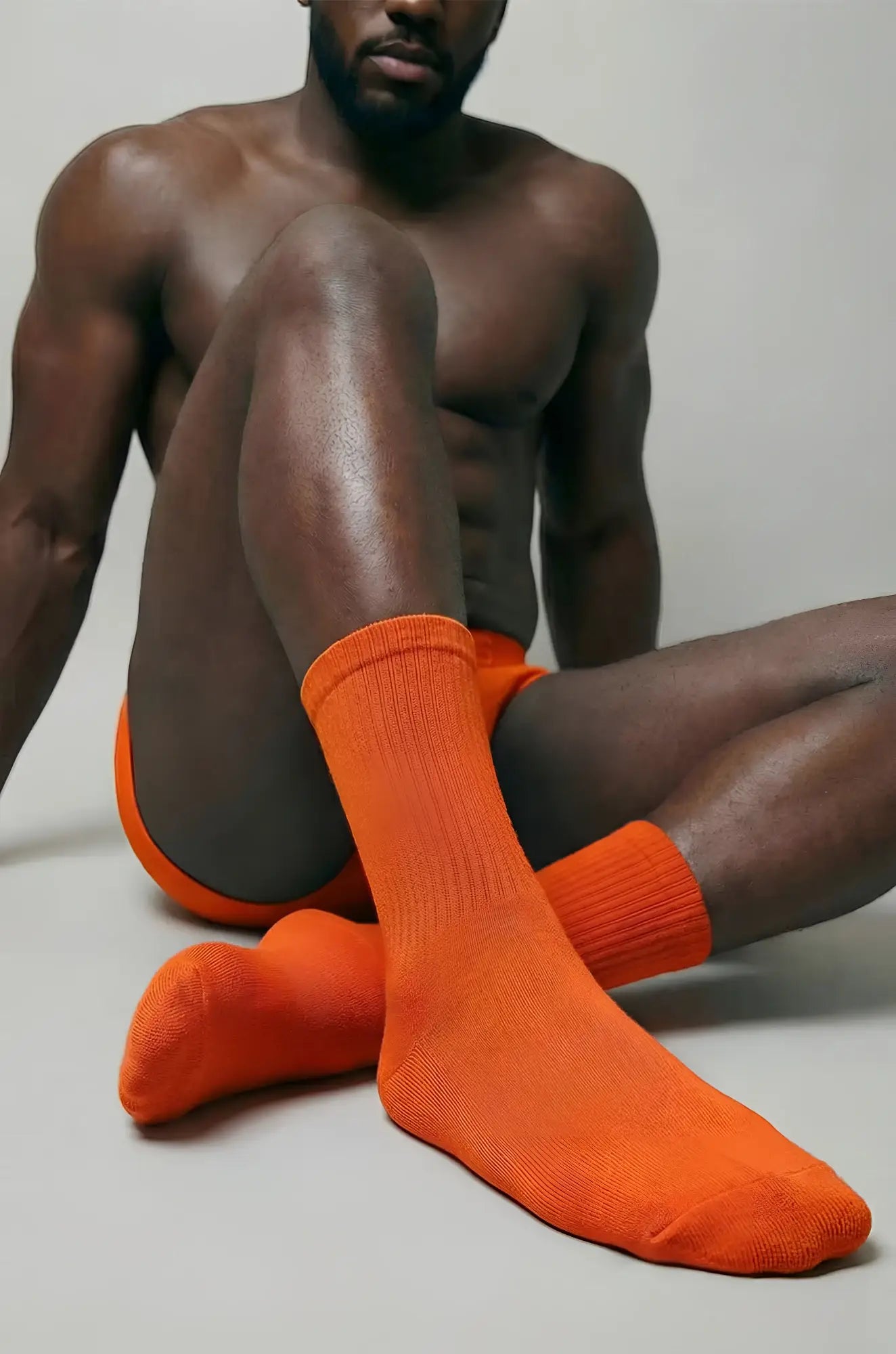 Rust orange crew sock featuring bright orange color ribbed cuff and smooth knit texture for comfortable wear