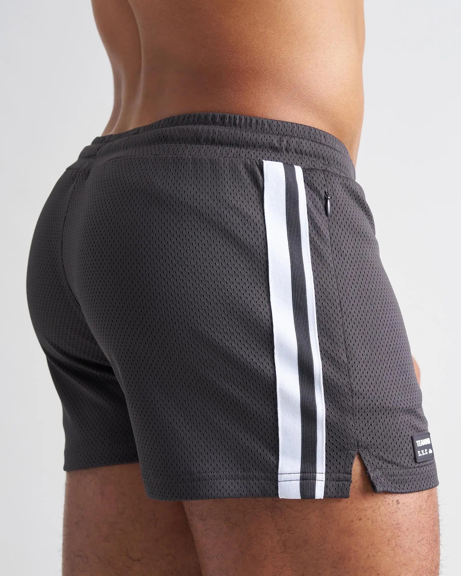 Dark gray mesh s.s.c. fraternity 3 inch athletic shorts with two white vertical stripes and black brand tag at hem