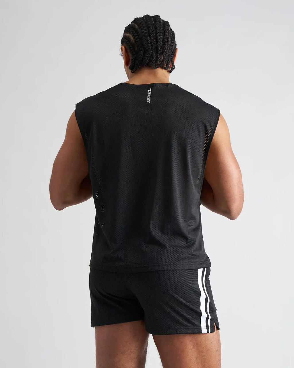 Black mesh sleeveless athletic muscle tank with subtle vertical logo on the back for breathable performance