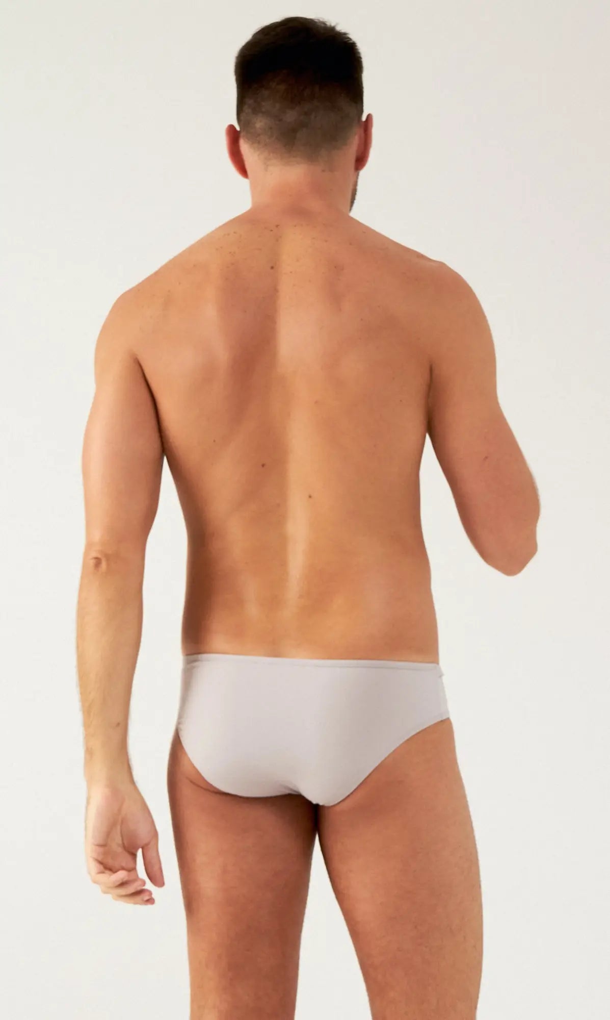 A sleek light gray saltire bikini brief with smooth fabric finish designed for comfortable swimwear use