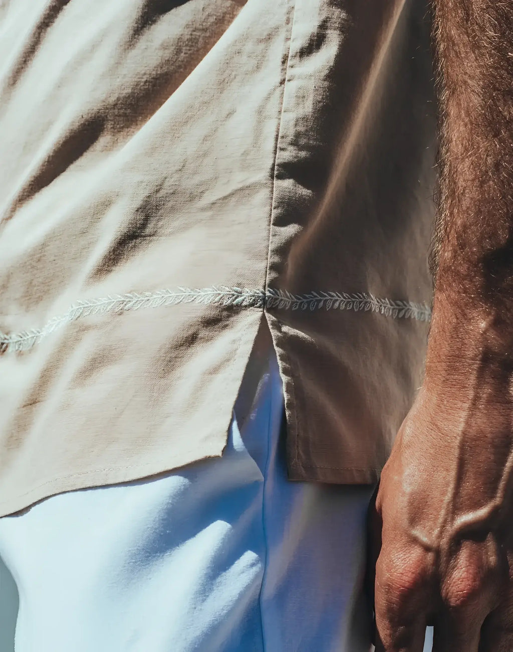 Beige santorini linen shirt with delicate white leaf embroidery along the seam on the back side