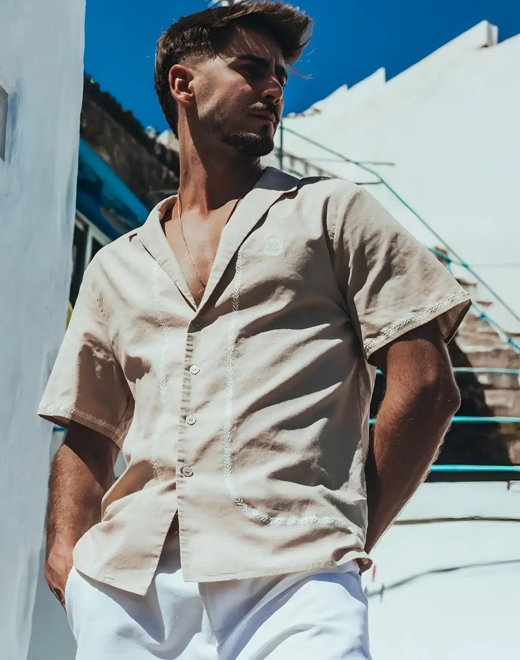 Beige santorini linen shirt with short sleeves and embroidered detailing along placket and hem