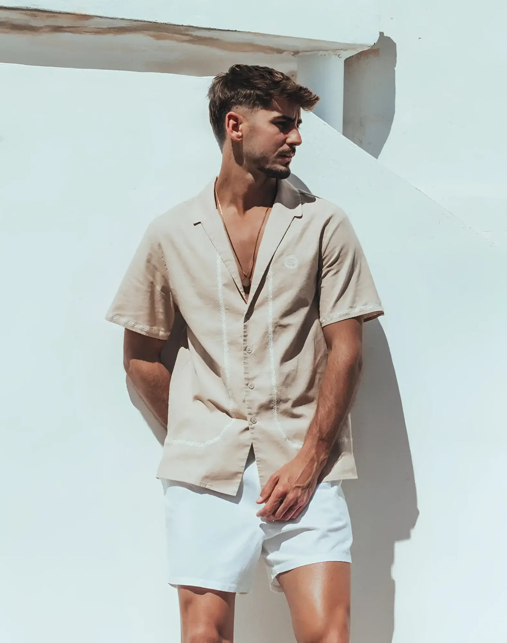 Santorini linen shirt beige short-sleeved button-up with subtle white stitching along placket and front seams
