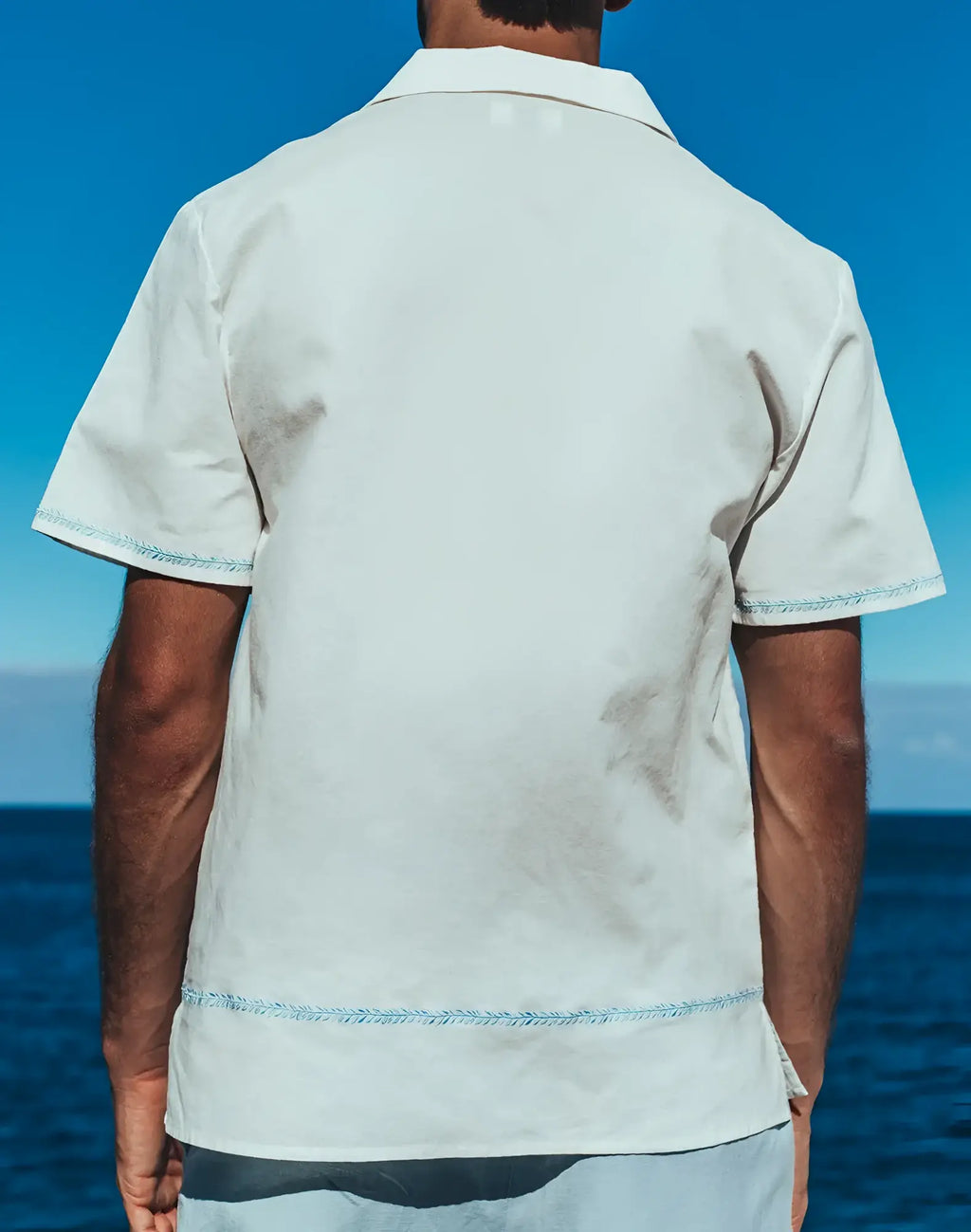 Santorini linen shirt white short-sleeved button-up with light blue stitching on hem and sleeve cuffs
