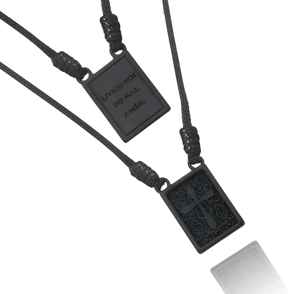 Black rectangular scapular cord men’s necklace with textured surface and engraved deliver us from evil amen inscription
