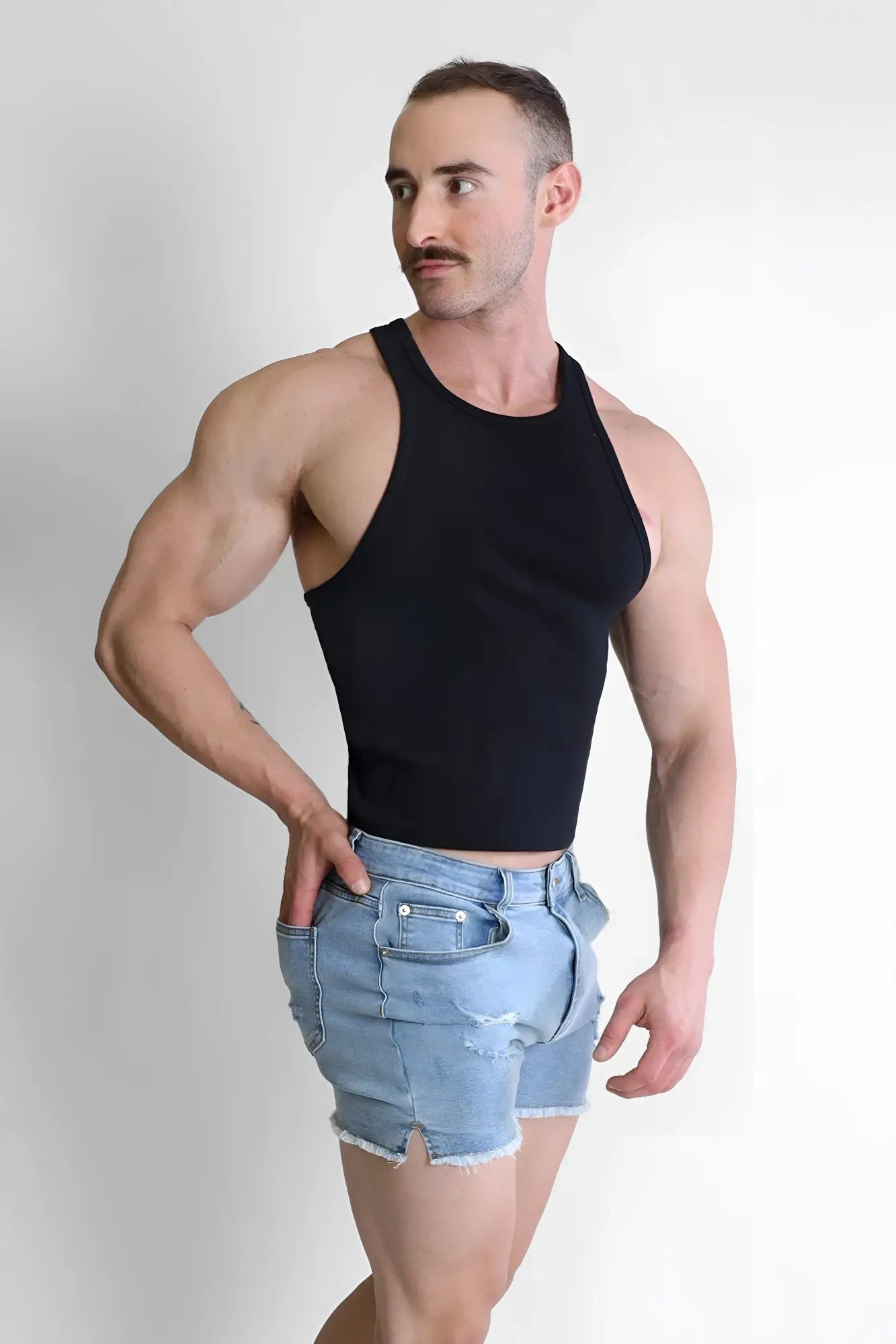 Black sleeveless crop top with scooped racer v neckline made of breathable fabric for active wear