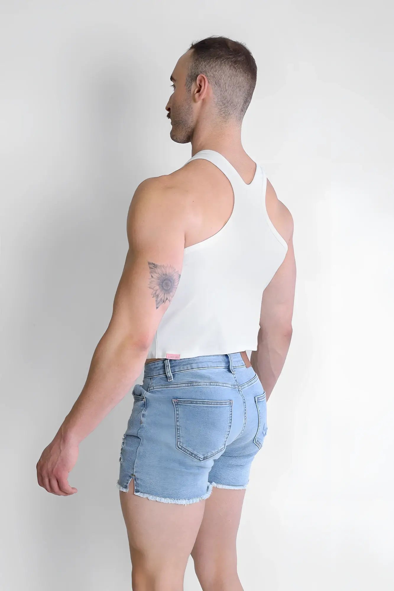White cropped tank top with a simple racerback design made of soft breathable fabric for casual wear back view