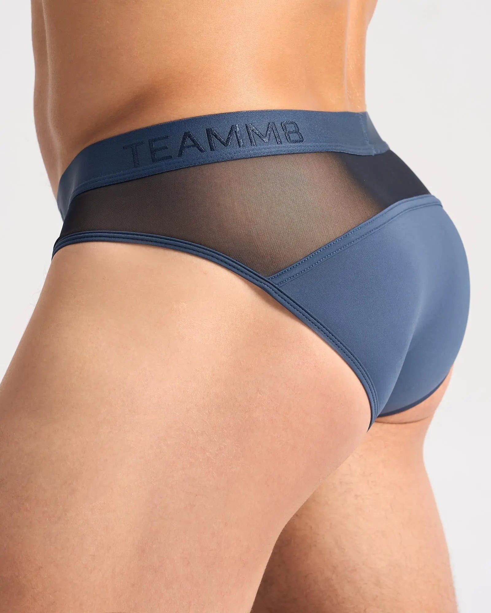 Blue teammb score sheer brief men’s briefs with seamless construction and blue mesh panel shown from the back