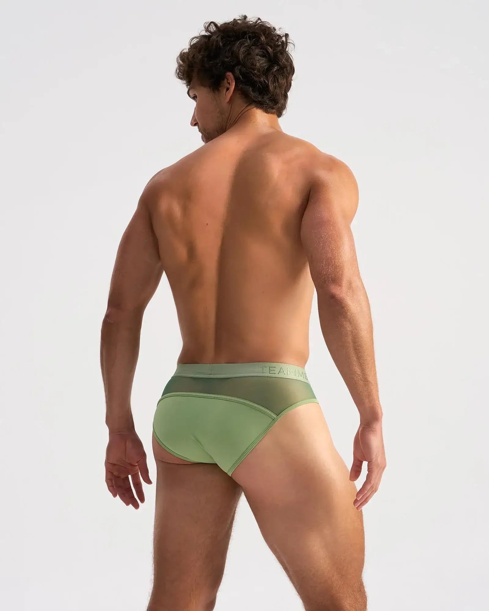 Light green score sheer brief with form-fitting fit, subtle mesh back panel, and elastic waistband with faint branding
