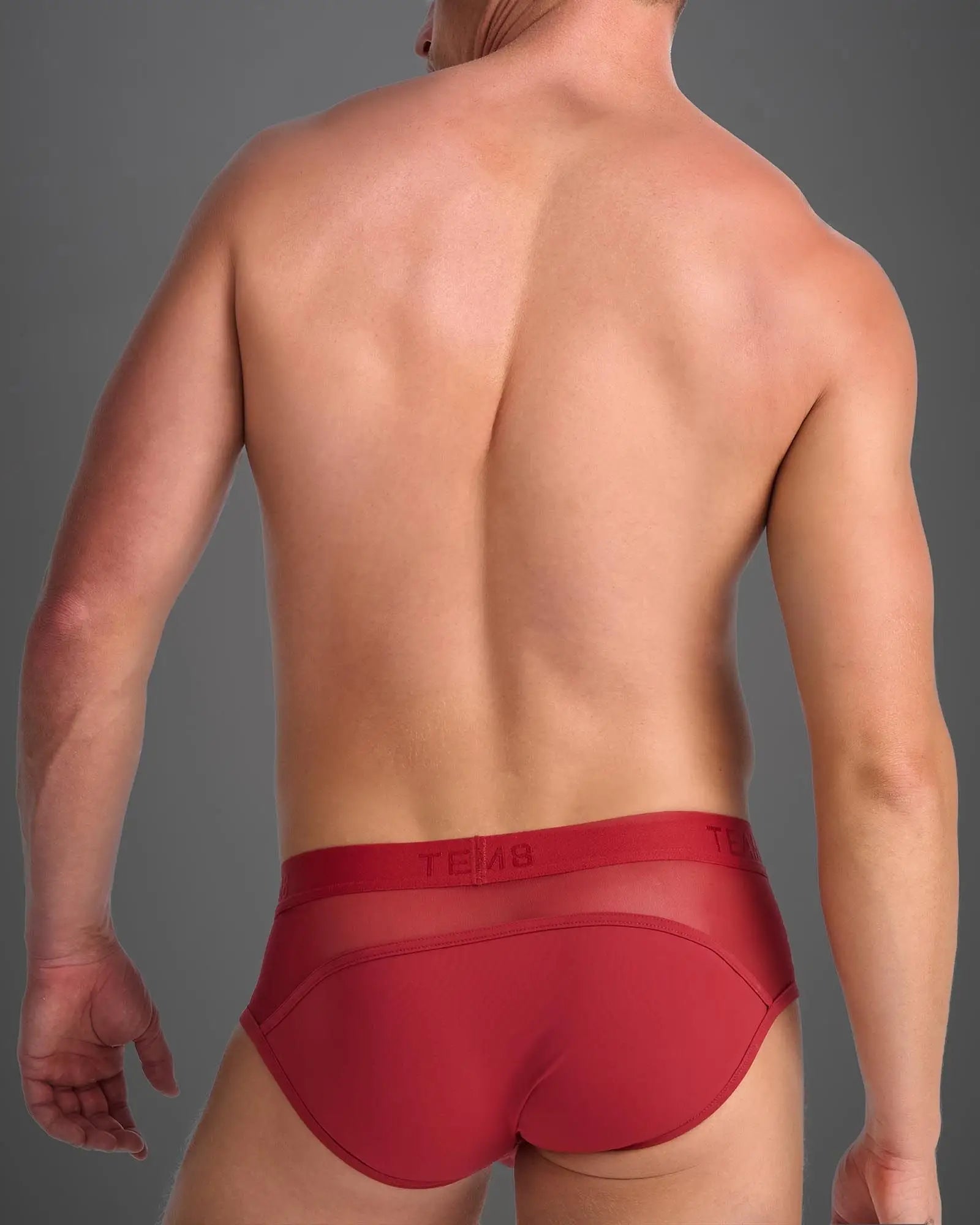 Red men’s score sheer brief showing back side with sheer mesh panel and elastic waistband for comfort
