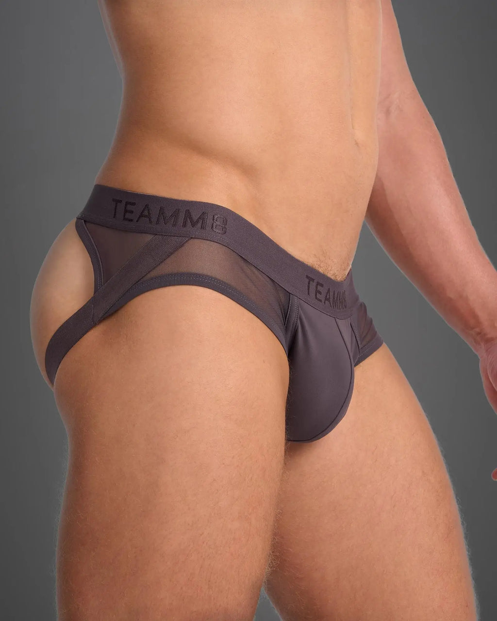 Dark gray mesh and solid fabric SCORE SHEER JOCK briefs with teamm8 branding on the waistband