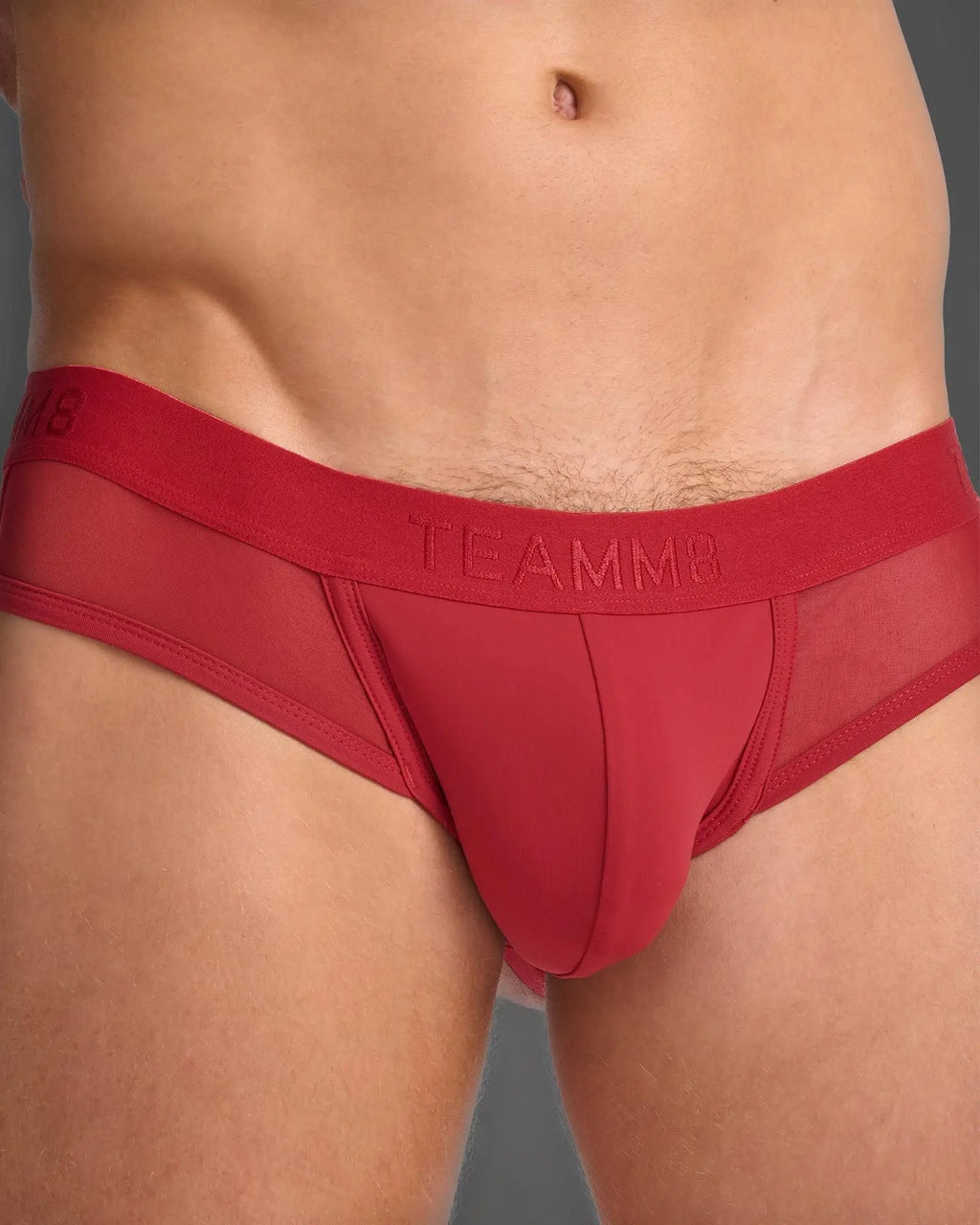 Red teammb score sheer jock men’s briefs with solid fabric front and sheer mesh sides in red color