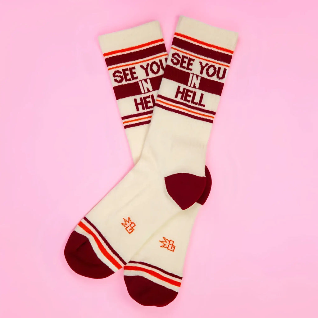 Cream-colored crew socks with maroon and orange stripes and see you in hell bold red lettering on the top cuff