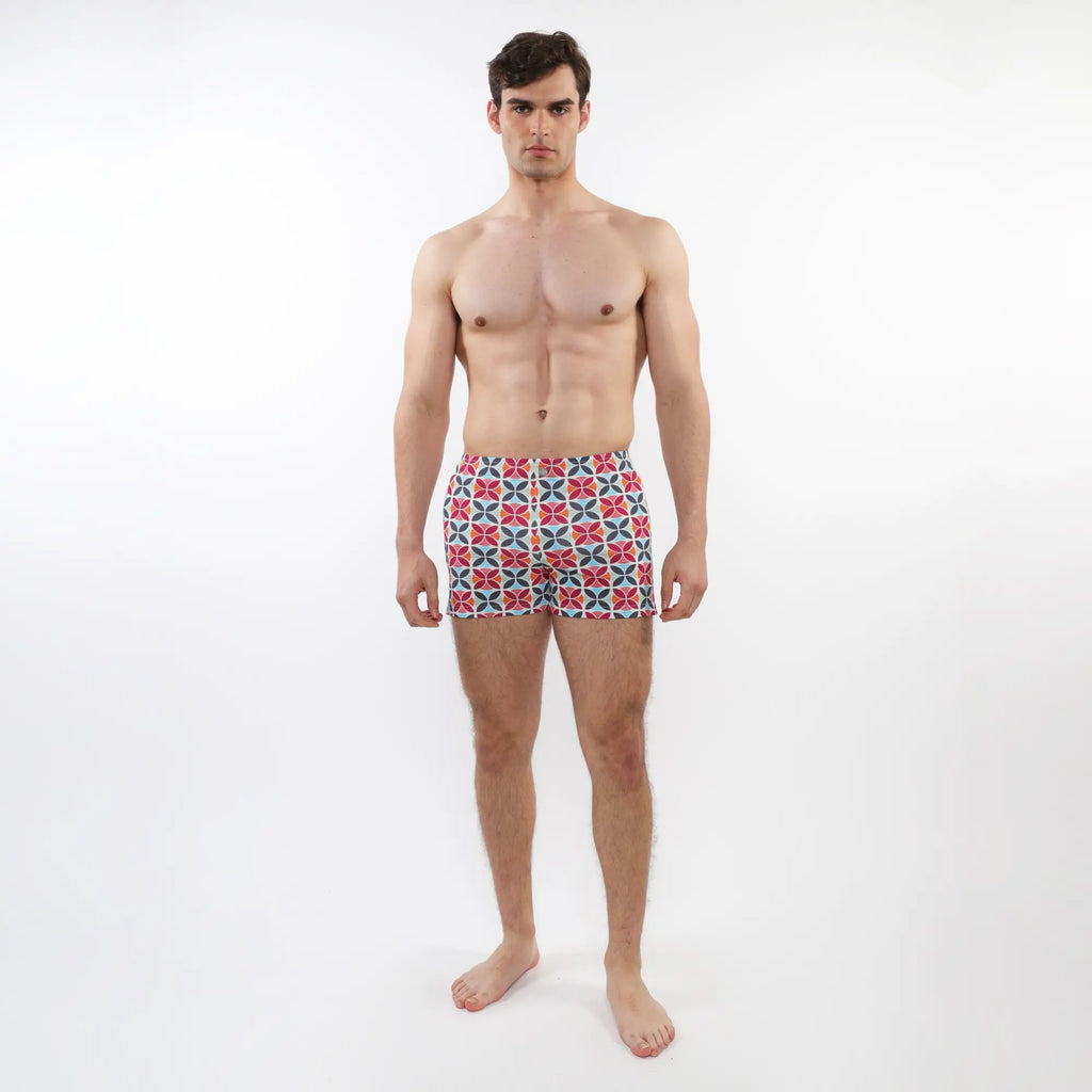 Men’s seersucker swim shorts with mesh lining featuring vibrant red blue and white geometric pattern