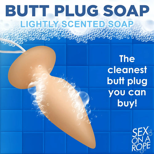 Sex on a Rope beige, butt-plug-shaped bar soap on a white string, set against a blue tiled background with bubbles.