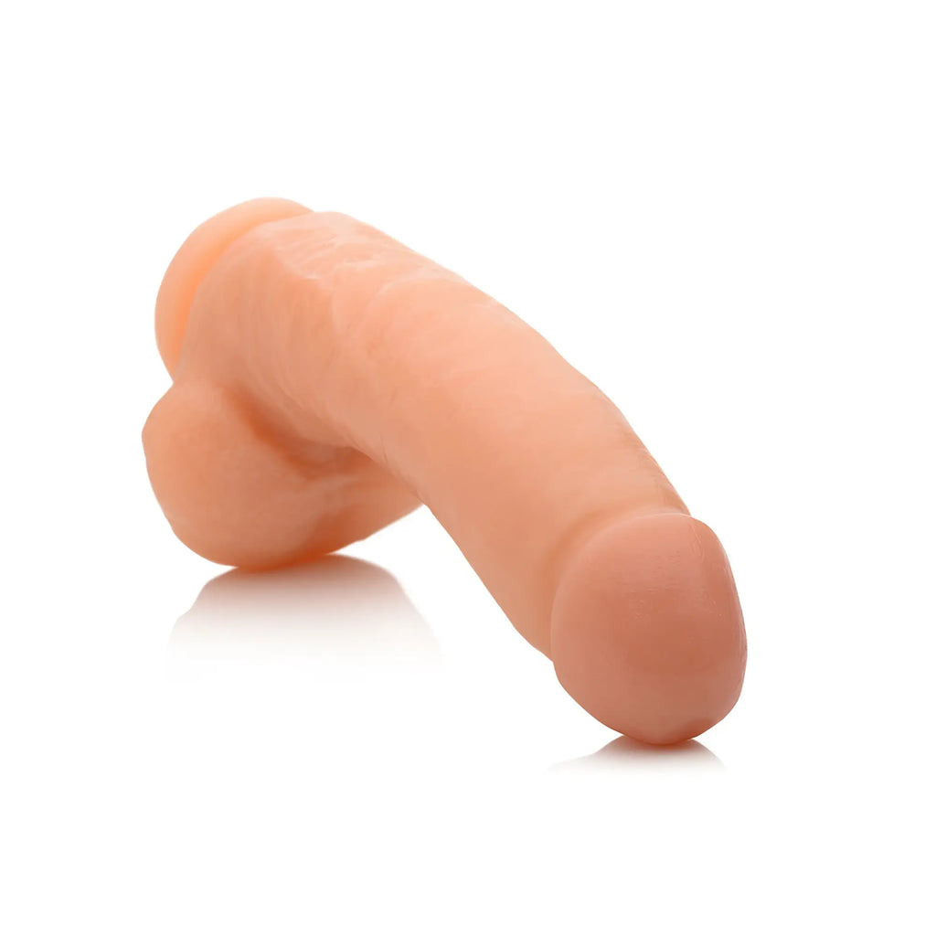 SexFlesh Stuff-Me Stefan realistic dildo in skin-tone, featuring textured, anatomical detailing on a white background.