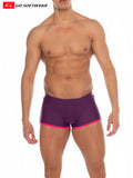 Purple Seychelles sq-cut swim trunks with bright pink trim and smooth fabric from go softwear featuring a snug fit