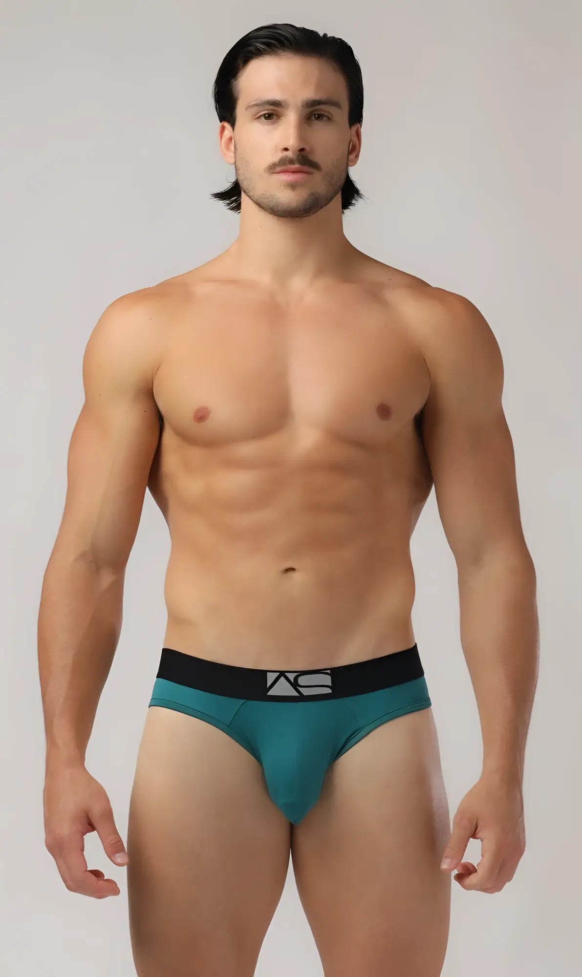 Teal shaped pouch briefs with a black waistband featuring the as logo for comfortable support
