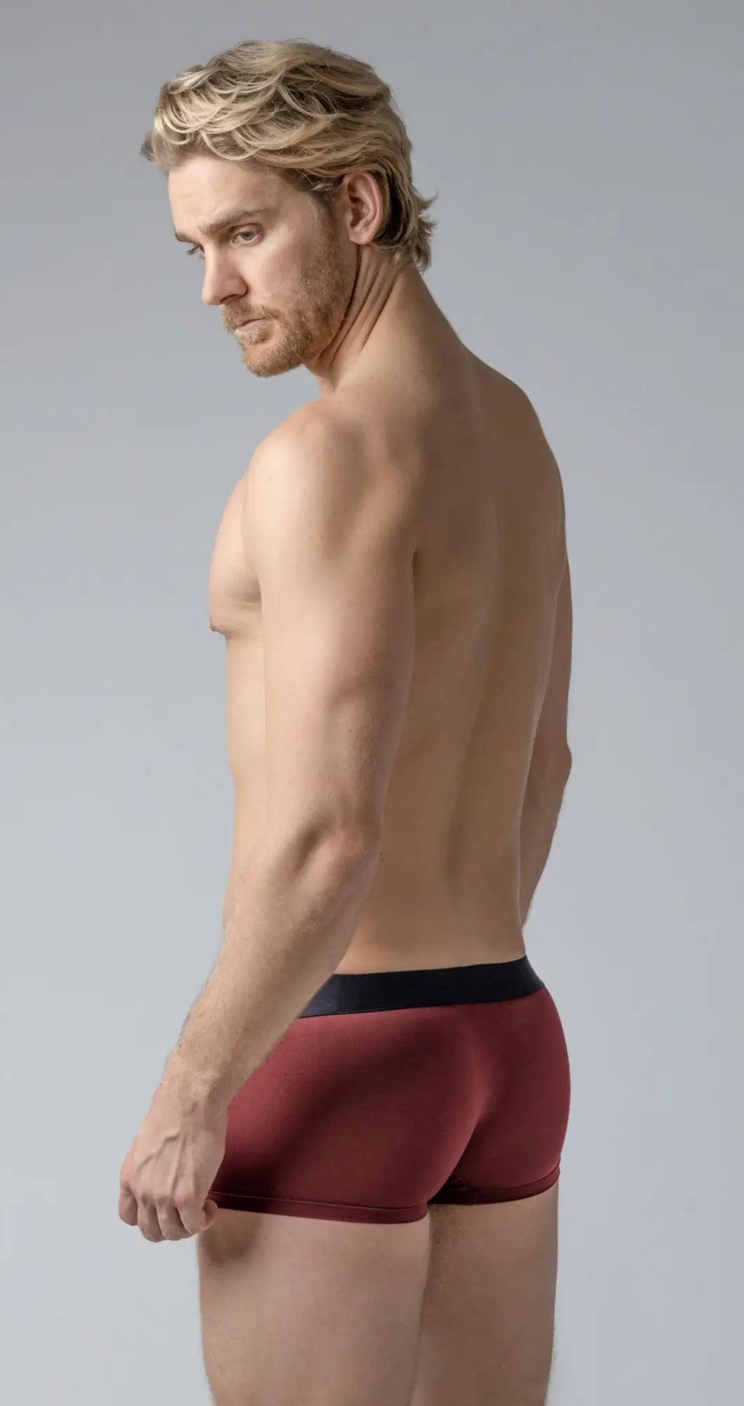 Maroon shaped pouch trunks briefs with black elastic waistband designed for shape and support
