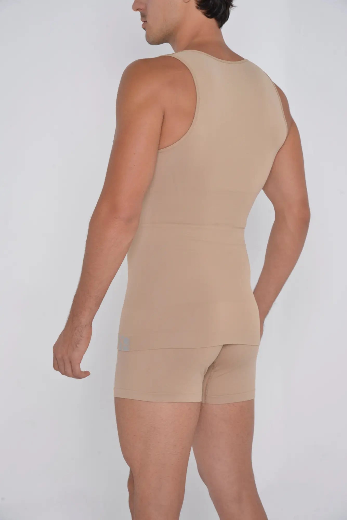Beige seamless compression shaper tank top and matching shorts set designed for comfortable body shaping and support