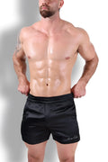 Black satin shimmerflex active shorts with subtle embroidered logo on lower right leg in midnight black