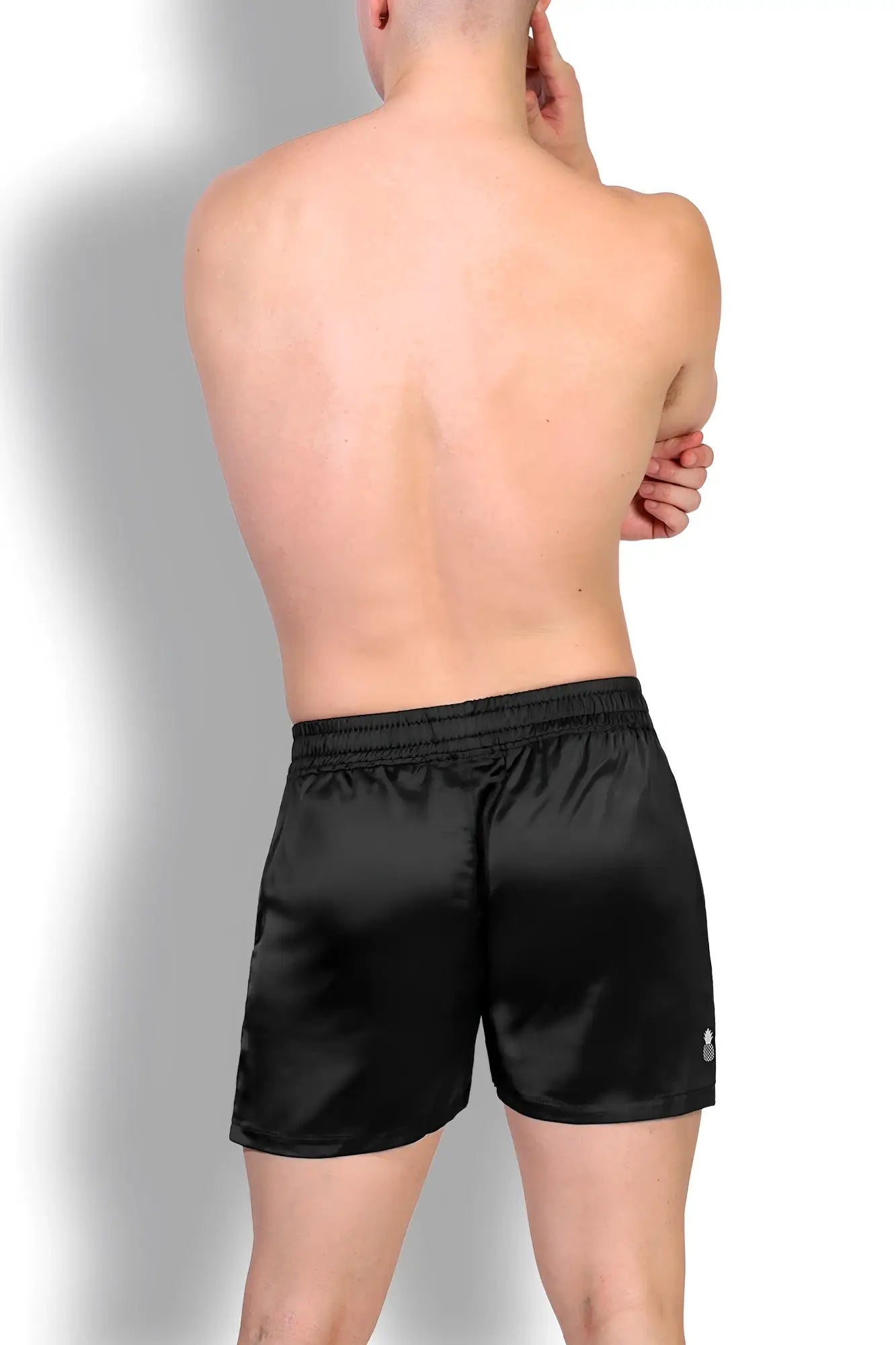 Black satin shimmerflex active shorts with subtle sheen and elastic waistband in midnight black