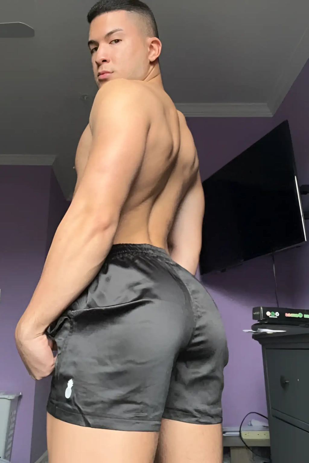 Black satin shimmerflex active shorts with drawstring waistband and white logo on left thigh in midnight black