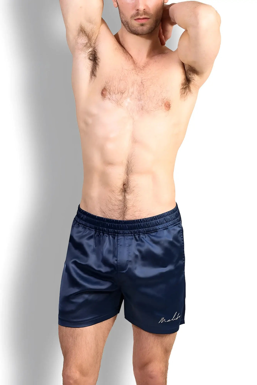 Navy satin shimmerflex active shorts with subtle embroidered logo on lower right leg for comfortable wear