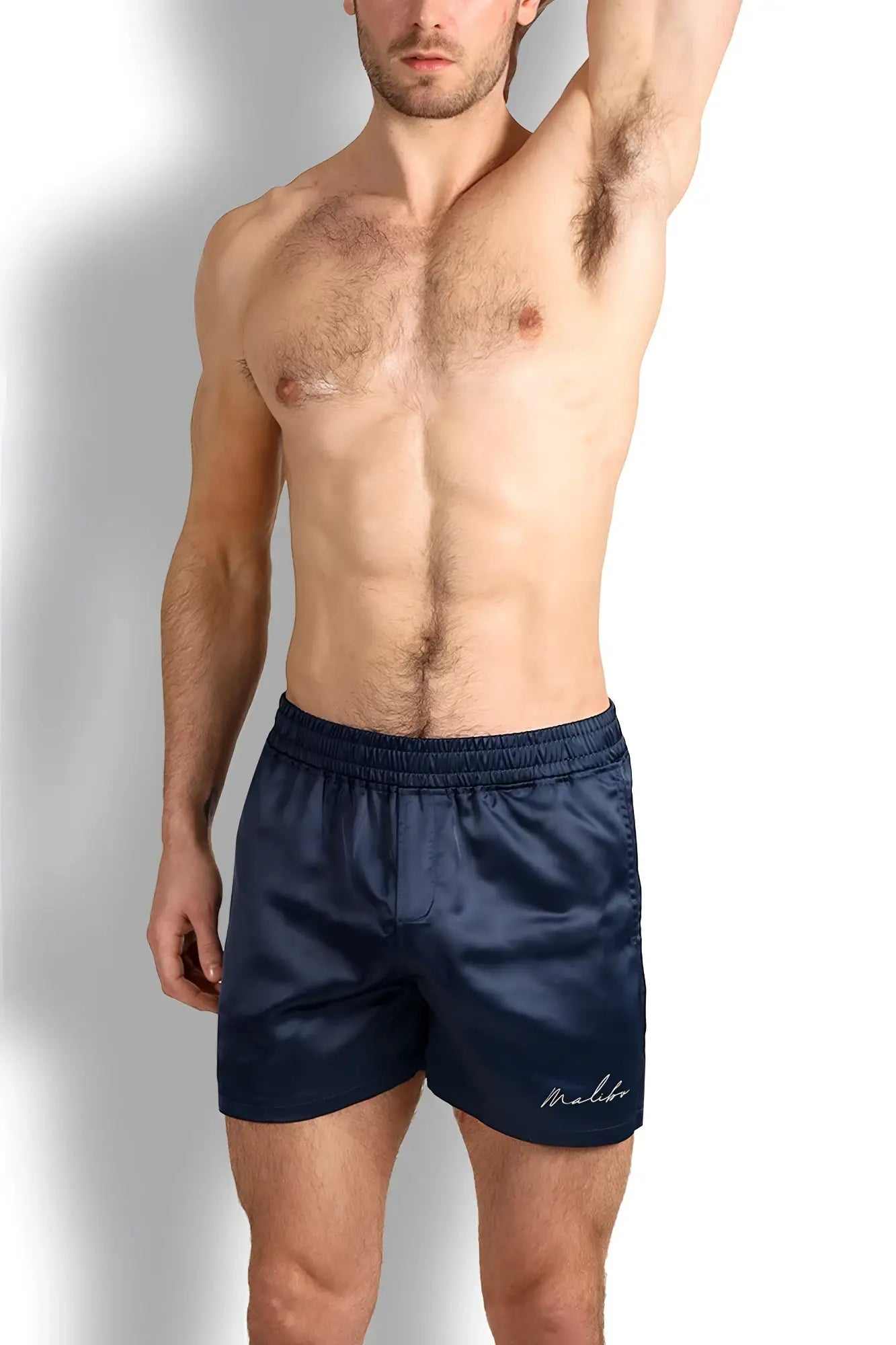 Navy blue satin shimmerflex active shorts with subtle embroidered logo on the lower right leg