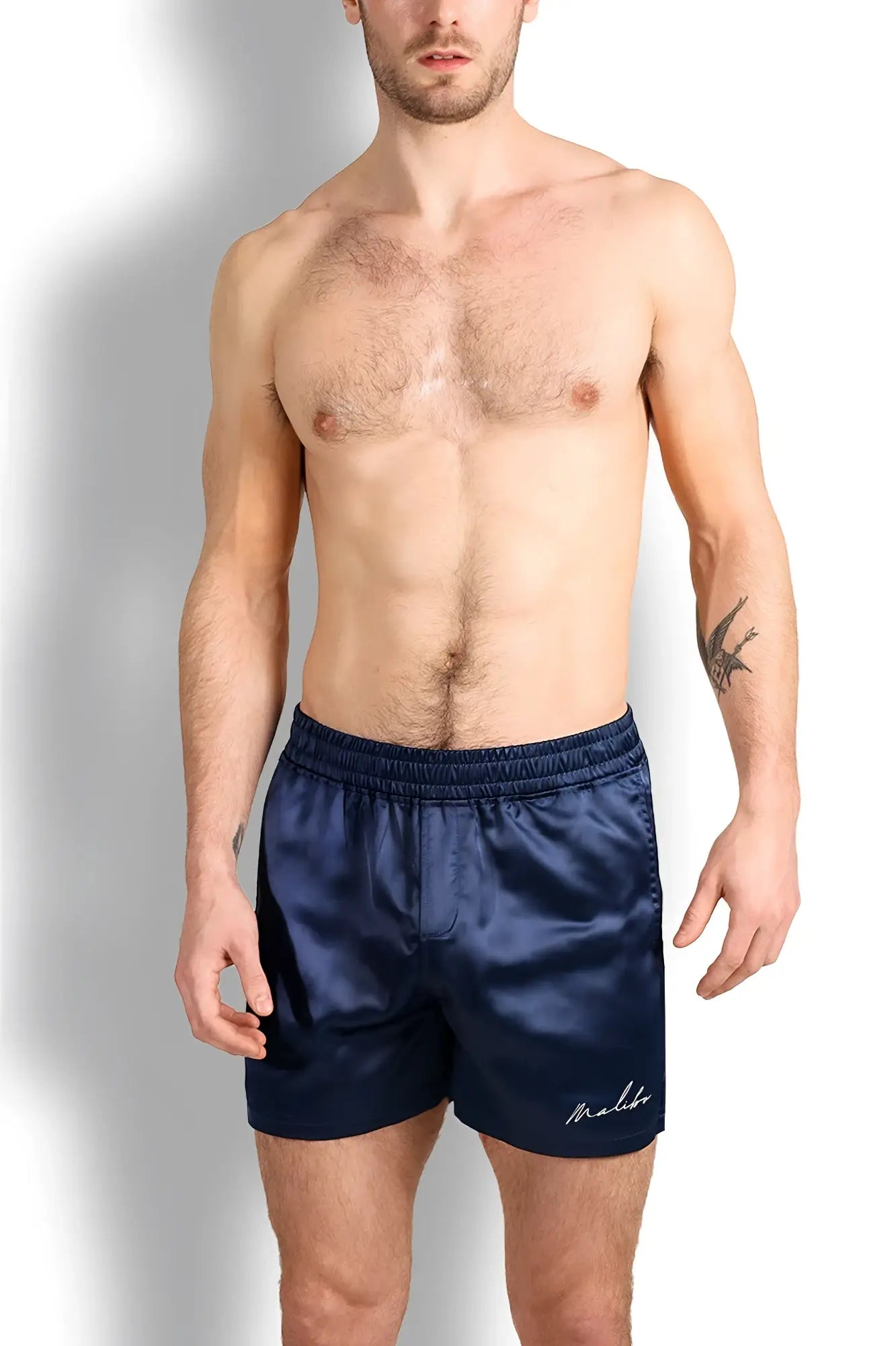 Navy blue satin shimmerflex active shorts with subtle embroidered logo on lower right leg