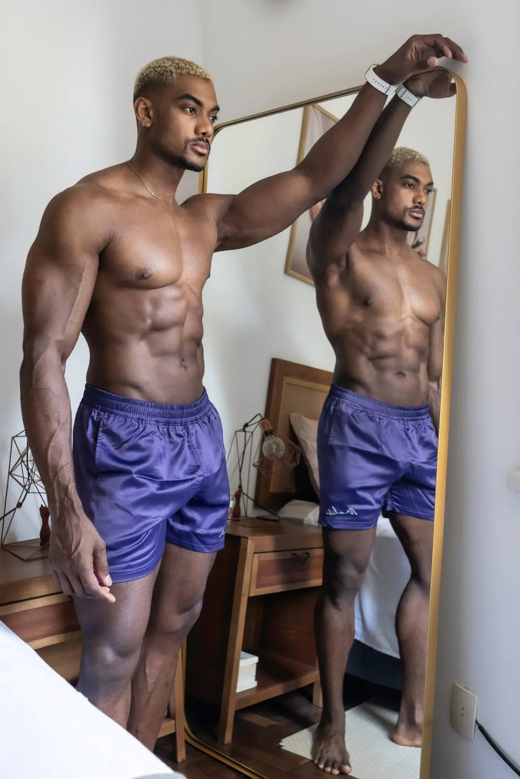 Shimmerflex active shorts plum are purple satin athletic shorts with a drawstring waistband and subtle brand logo