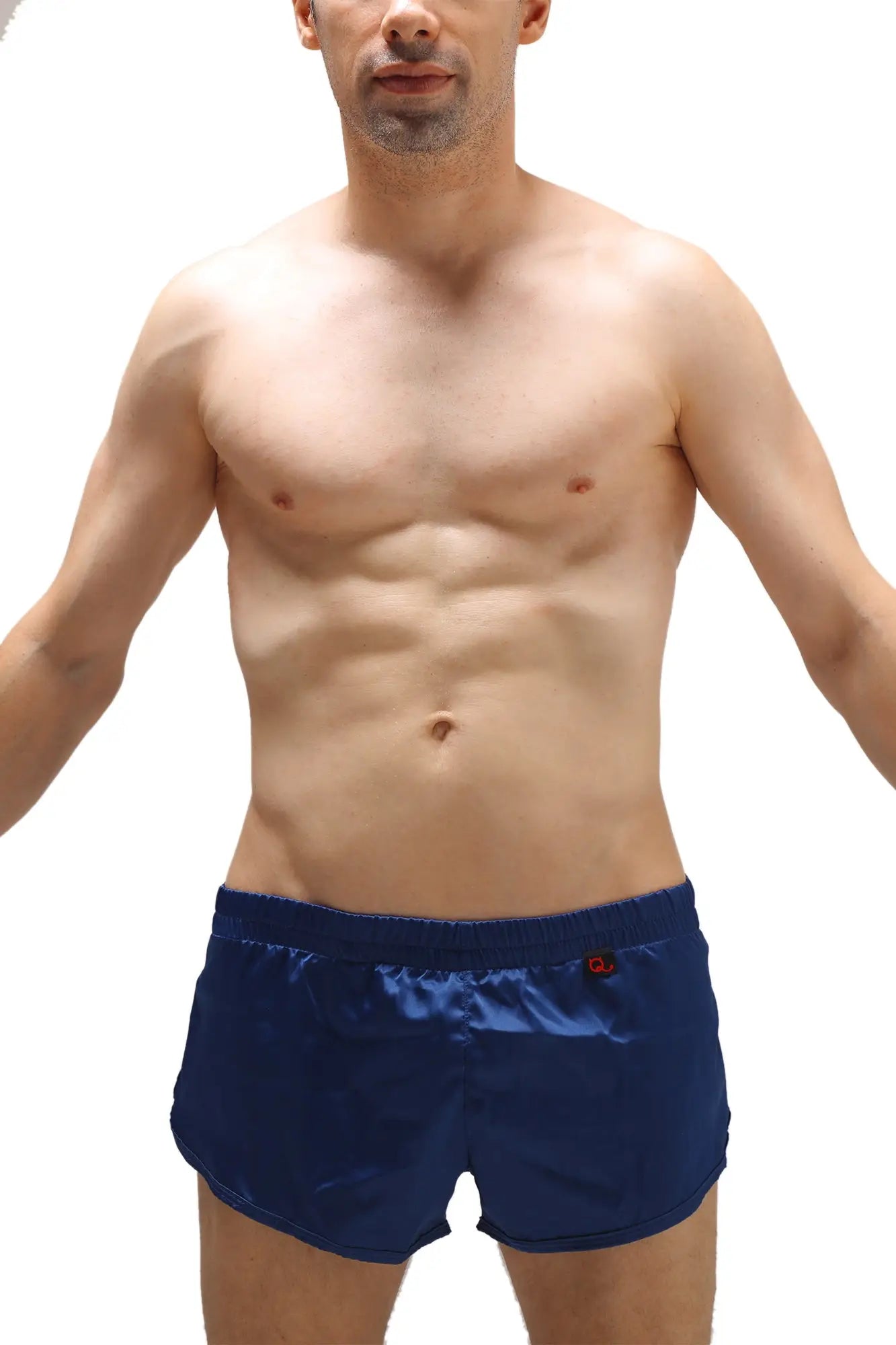 Navy blue satin swim trunks with a red logo on the waistband featuring a built-in jockstrap for support