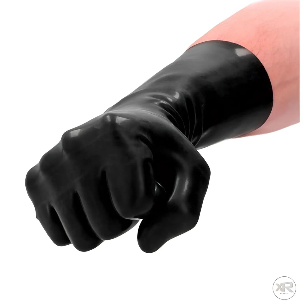 Shots FistIt latex glove in glossy black worn on a hand formed into a fist.