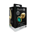 Gold metal butt plug with a prominent emerald green gemstone head by ouch medium round gem design