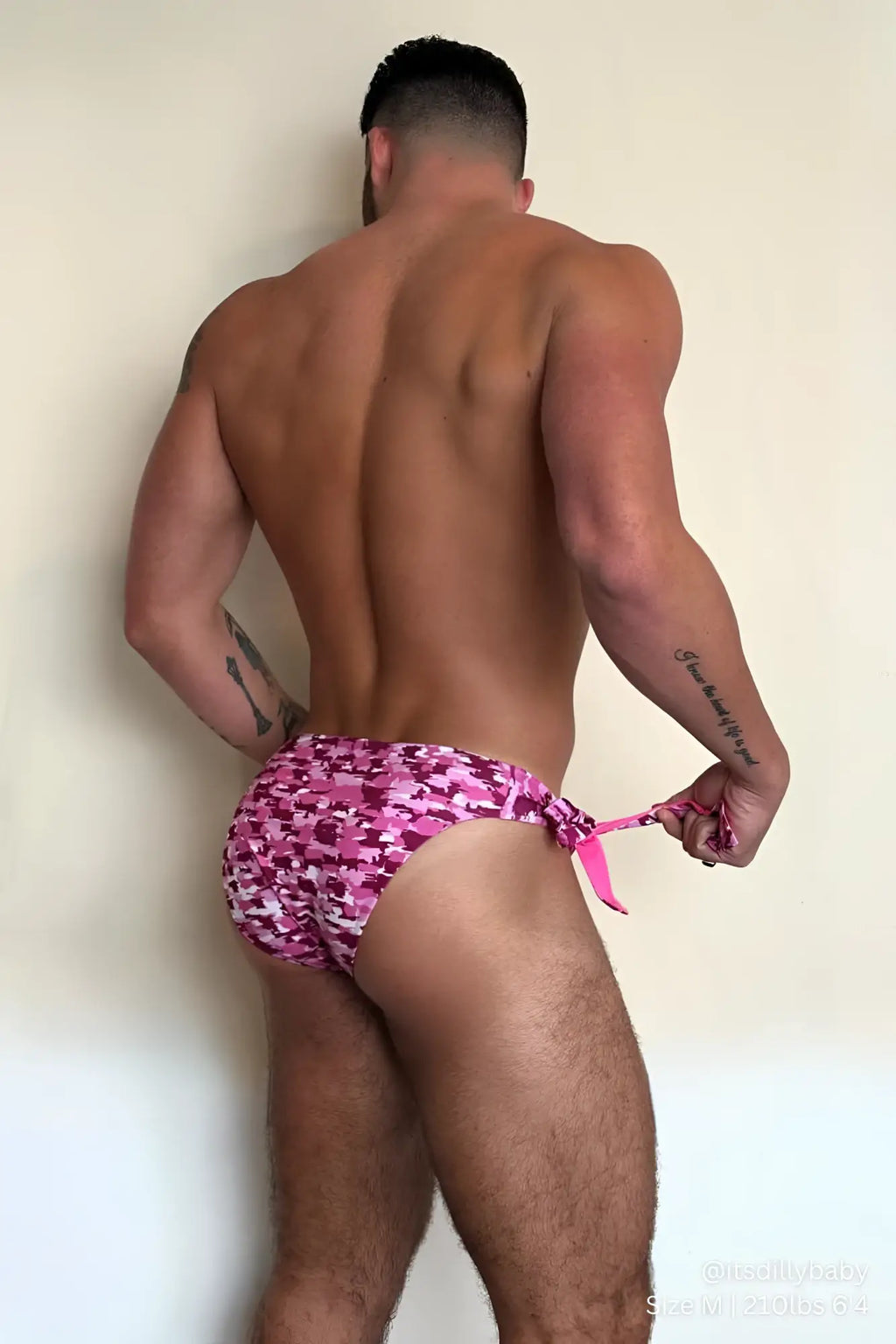 Side-tie swim briefs in reversible pink and white camouflage pattern with a pink waist tie for swimming and beachwear