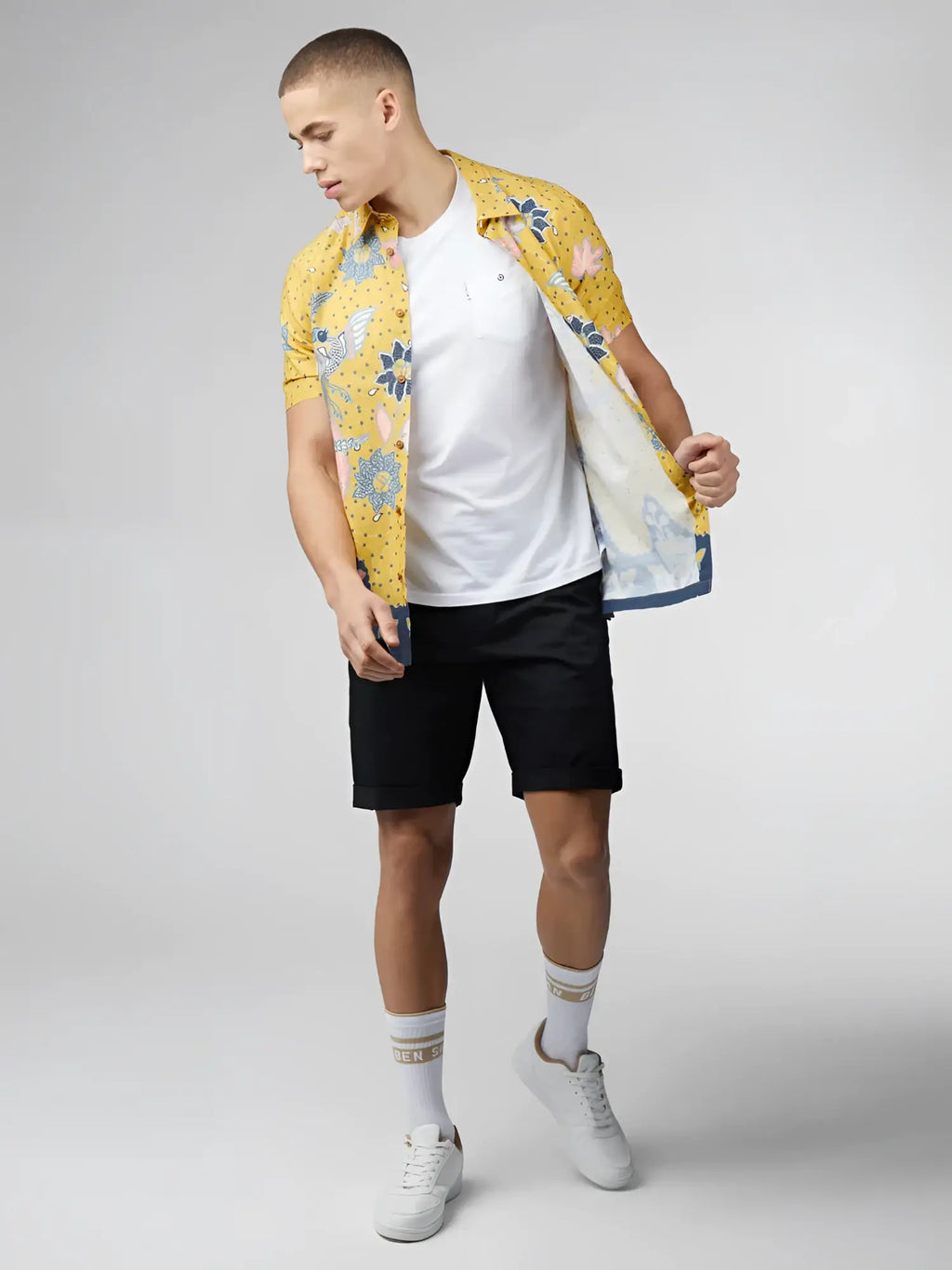 Yellow floral short-sleeved shirt with blue and pink accents featuring a signature abstract botanical print design