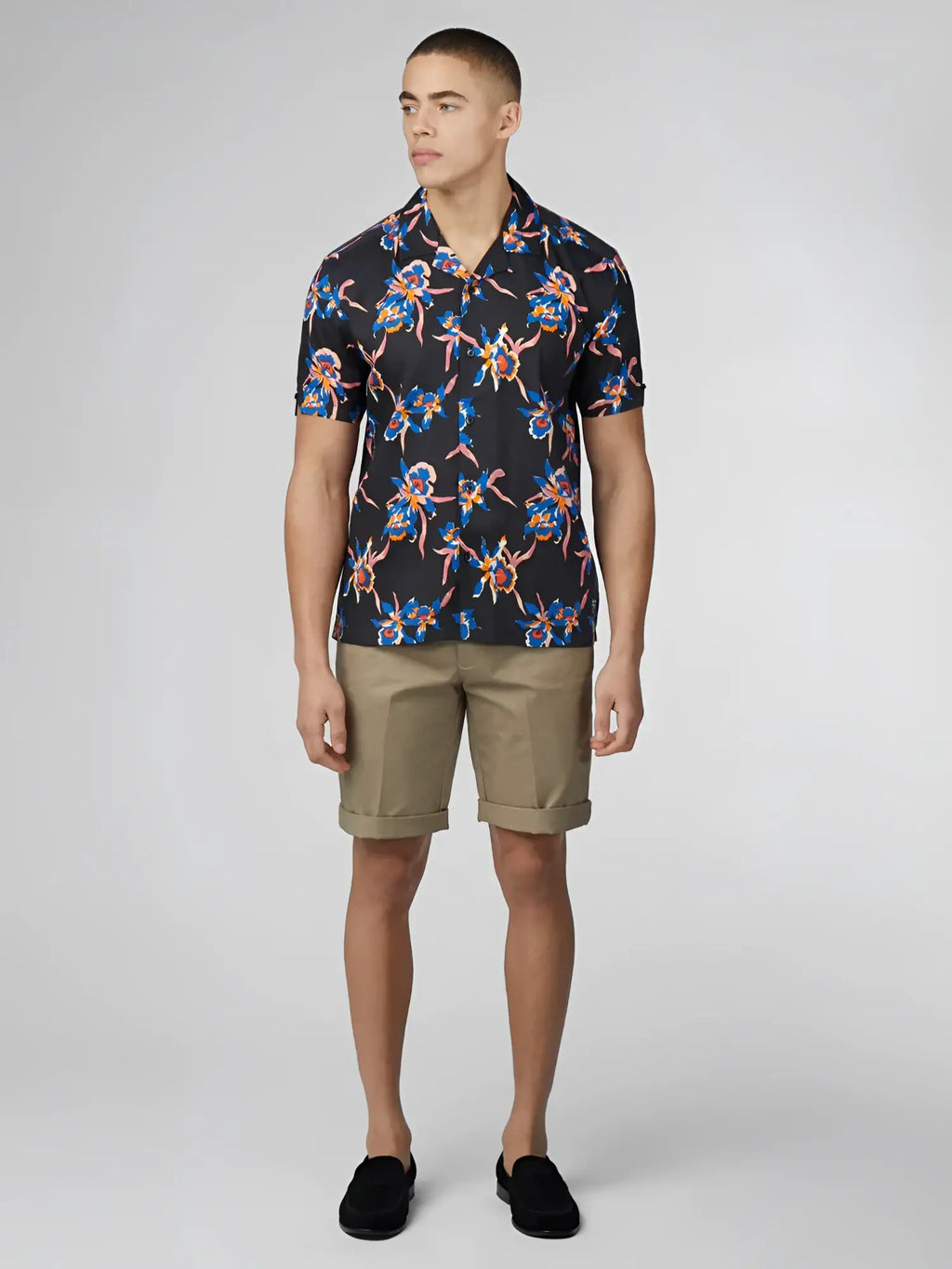 Black short-sleeved button-up shirt with vibrant blue pink and orange floral pattern signature botanical print