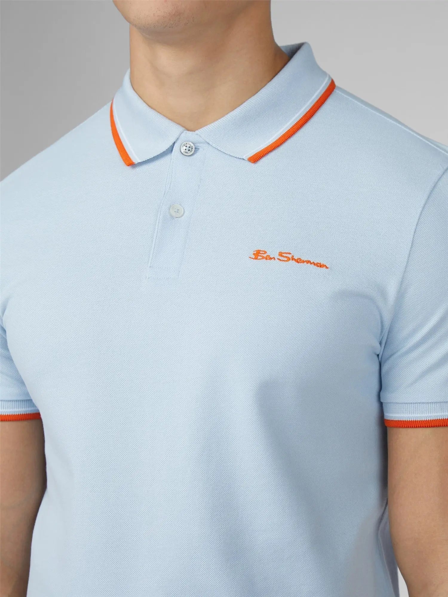 Light blue pique signature polo shirt with orange trim and ben sherman embroidered logo on collar and cuffs