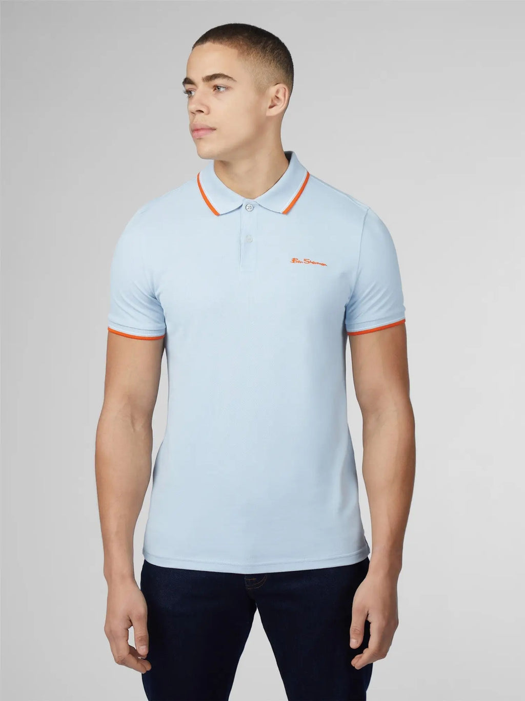 Light blue signature polo short-sleeved shirt with orange trim and small embroidered chest logo for casual wear
