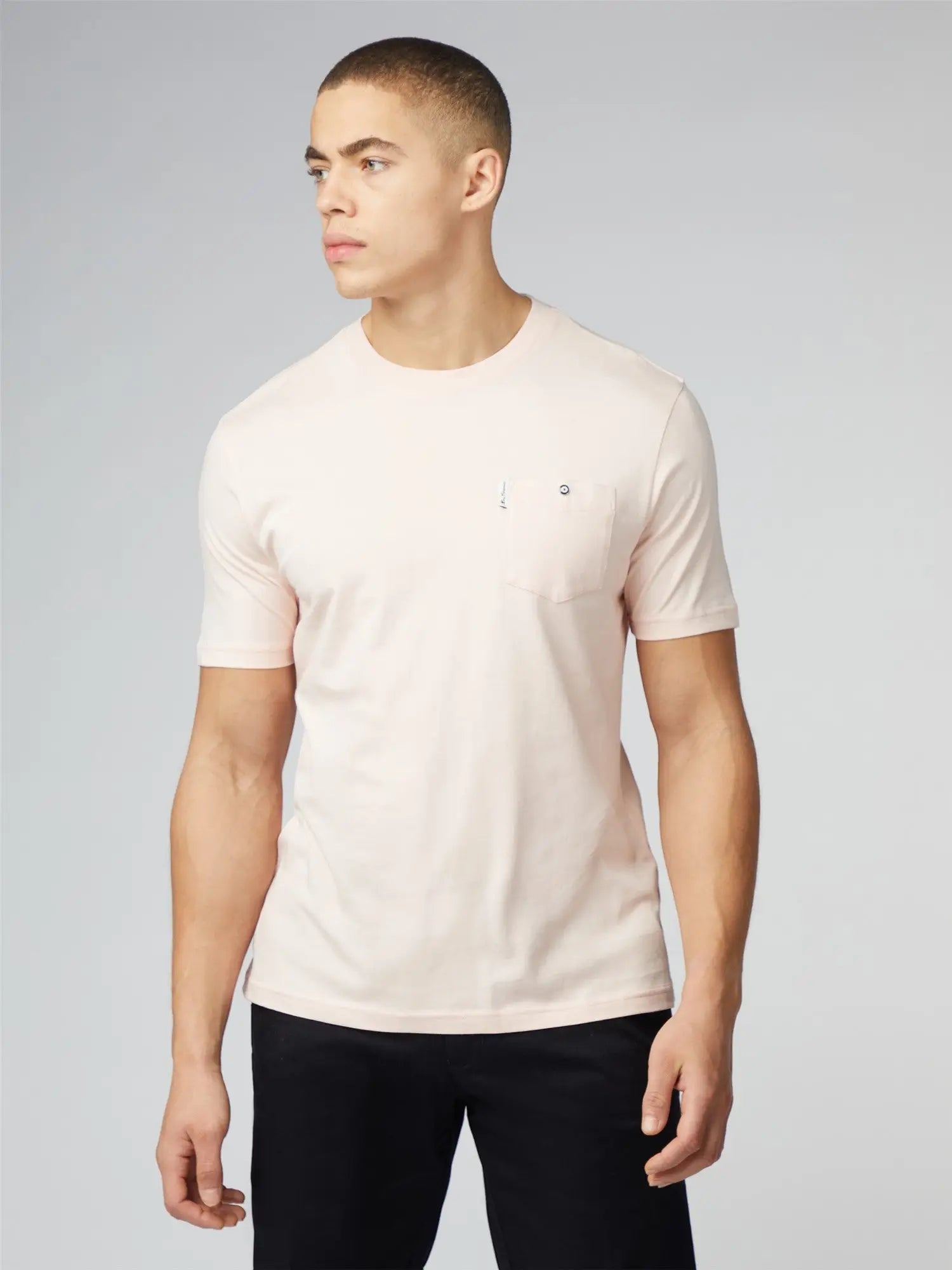 A soft blush pink signature t-shirt with a chest pocket short sleeves and a subtle embroidered logo on left chest