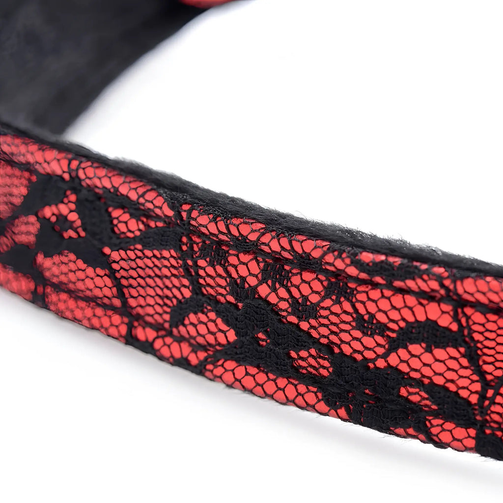 Silicone ball gag with red and black lace headband featuring intricate floral patterns for intimate use
