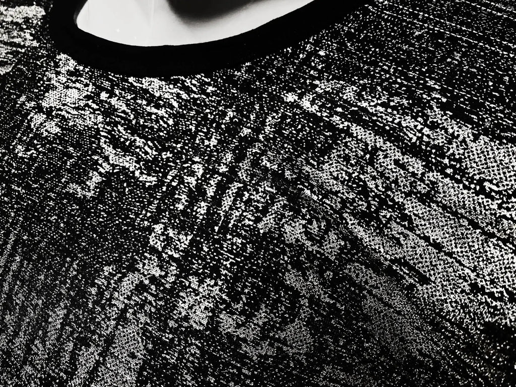 Black lace silver leaf tee with intricate textured pattern showcasing elegant and detailed craftsmanship