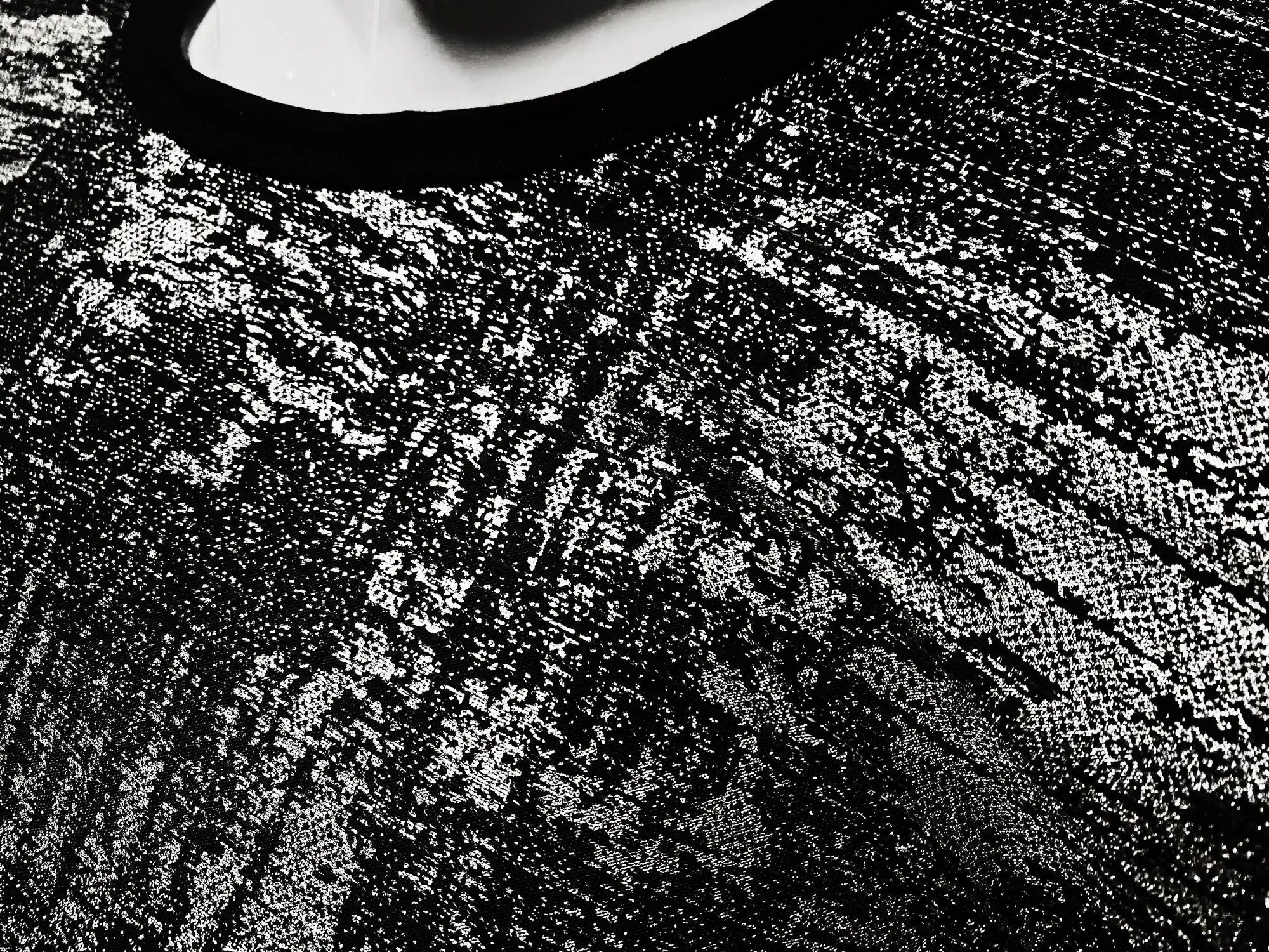 Black lace silver leaf tee with intricate textured pattern showcasing elegant and detailed craftsmanship