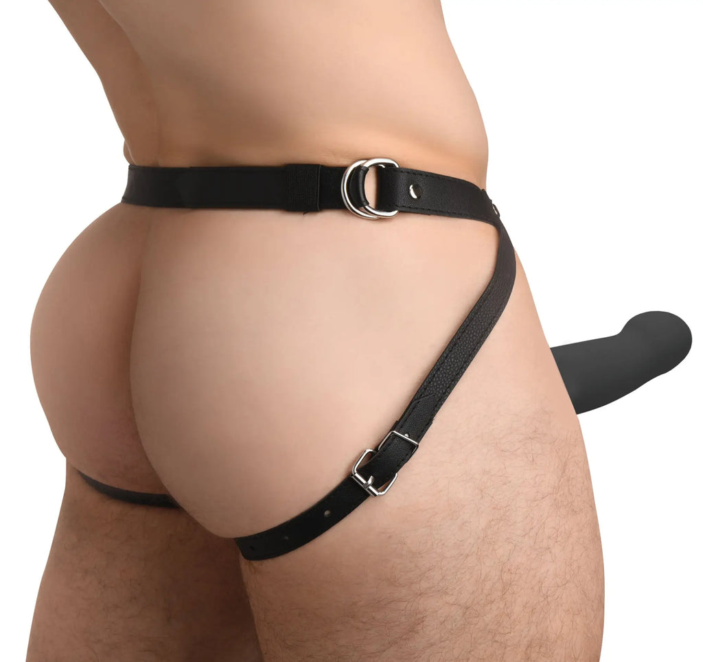 Size Matters 2-inch vibrating silicone penis sheath in black, worn with a black leather-style strap harness.