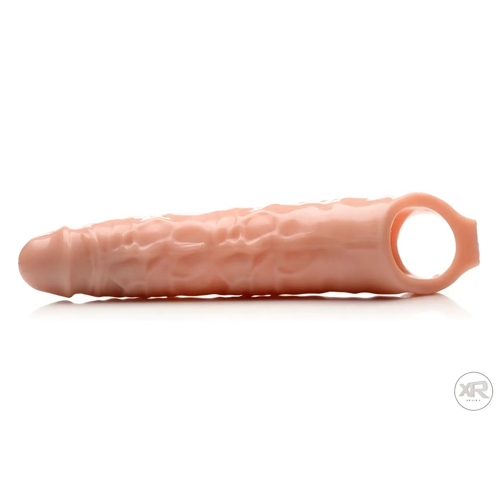 Size Matters 3 Inch Extender Sleeve in flesh-colored, textured silicone, shown horizontally on a white background.