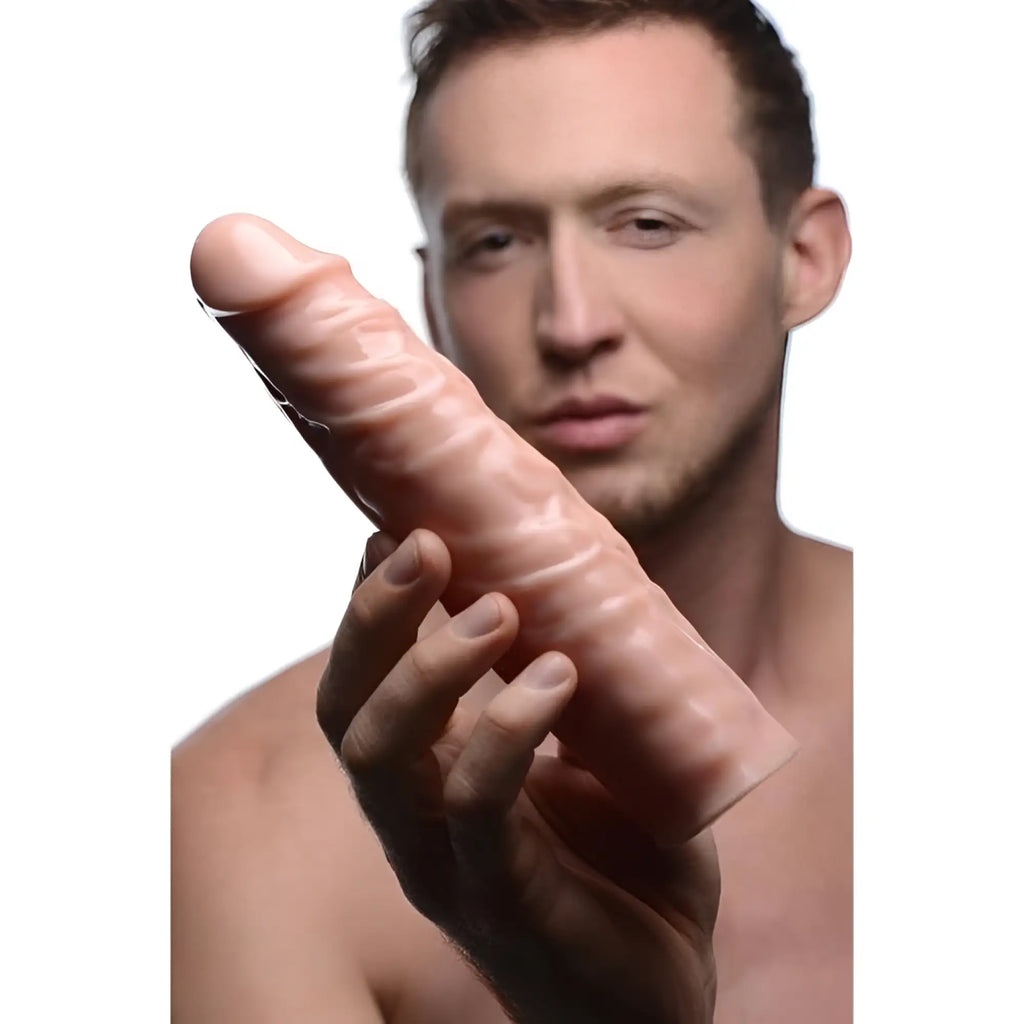 A man holding a textured, flesh-colored Size Matters 3-inch penis enhancer sleeve against a white background.